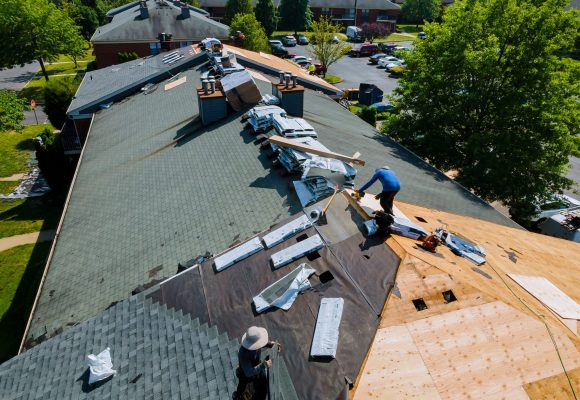 Construction worker on a renovation roof the house installed new shingles