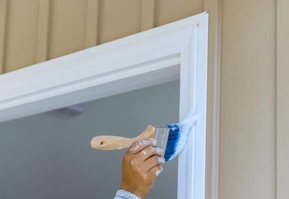 Painter are used paintbrush by to paint wooden moldings on door trims